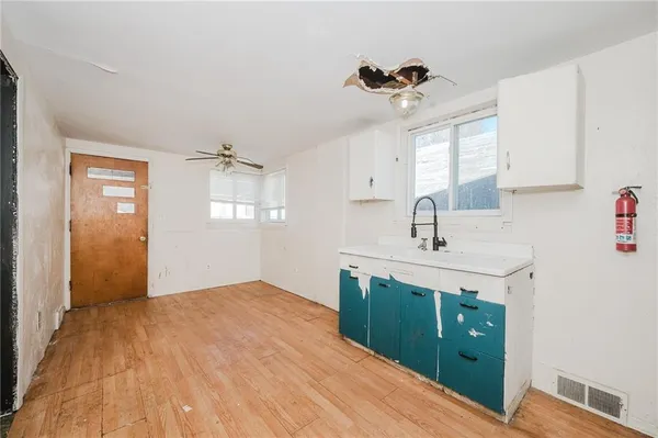 a kitchen with a sink cabinets and window