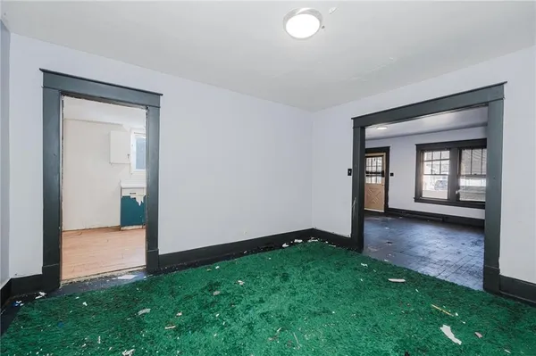 an empty room with yard & mirror