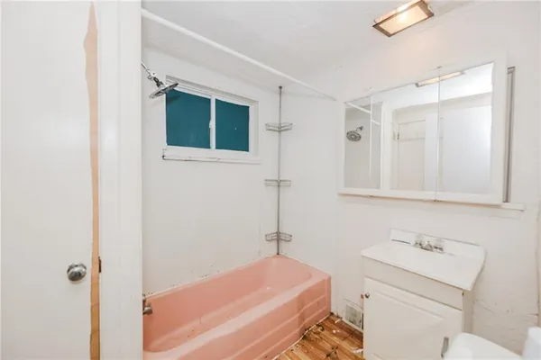 a bathroom with a sink toilet vanity and shower