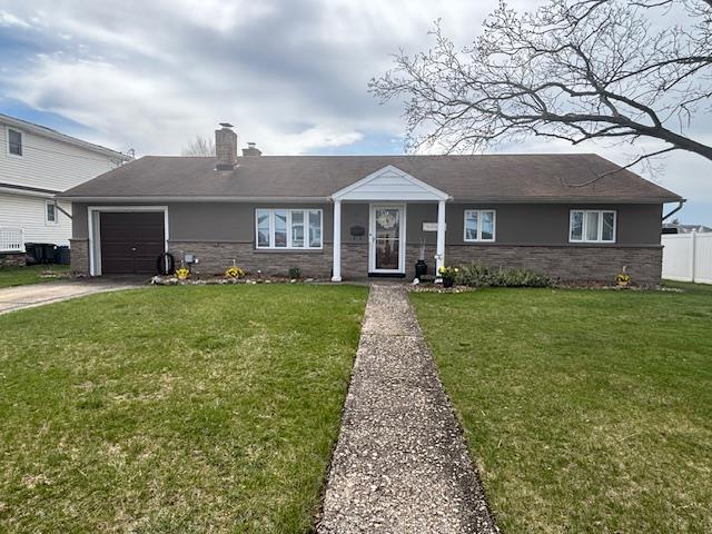 41 West Santa Barbara Road Lindenhurst, NY 11757 - Photo 1 of 1 View of front of property featuring a chimney, a front lawn, driveway, an attached garage, and fence