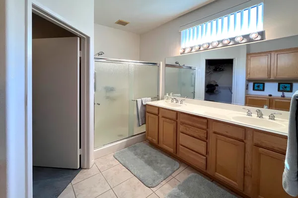 a bathroom with a double vanity sink and a mirror