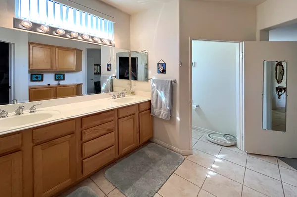 a spacious bathroom with a granite countertop sink mirror and toilet