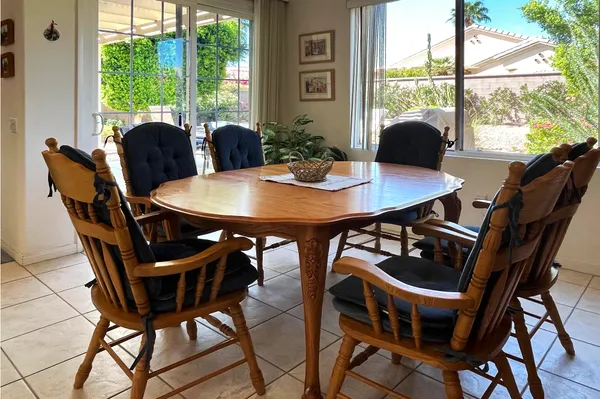 a view of a dining room with furniture and window