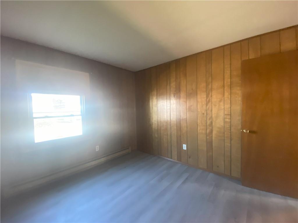 203 Irving Avenue Latrobe, PA 15650 - Photo 13 of 17 a view of an empty room with window and wooden floor
