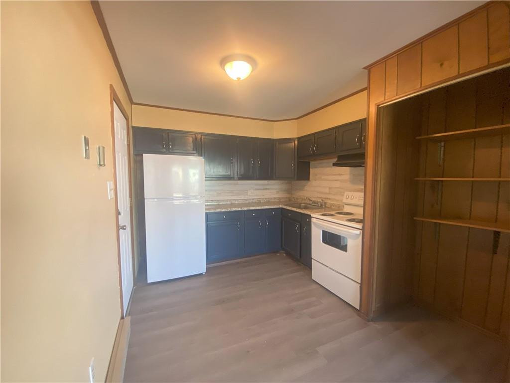 203 Irving Avenue Latrobe, PA 15650 - Photo 4 of 17 a kitchen with a stove and a refrigerator