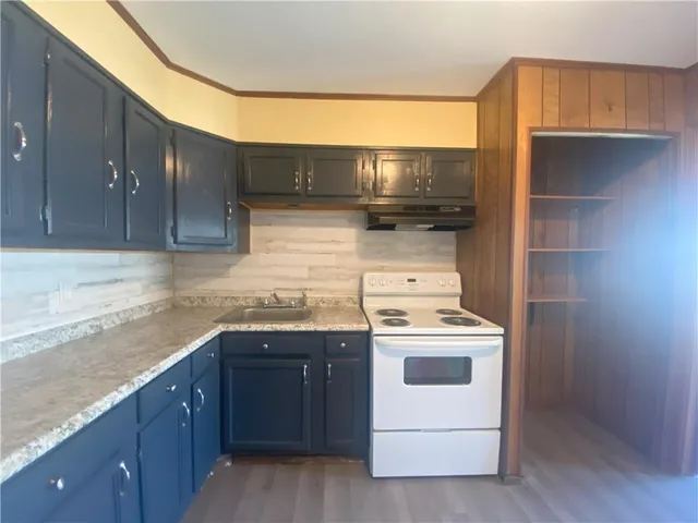 a kitchen with a stove and a microwave