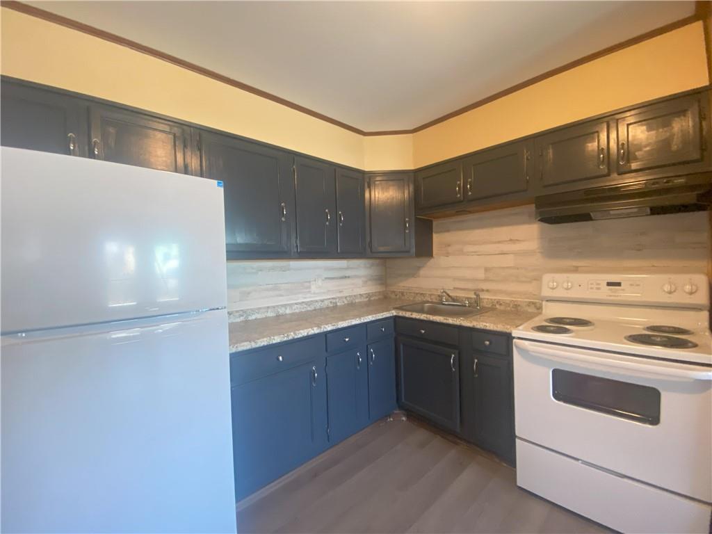 203 Irving Avenue Latrobe, PA 15650 - Photo 6 of 17 a kitchen with a stove cabinets and microwave