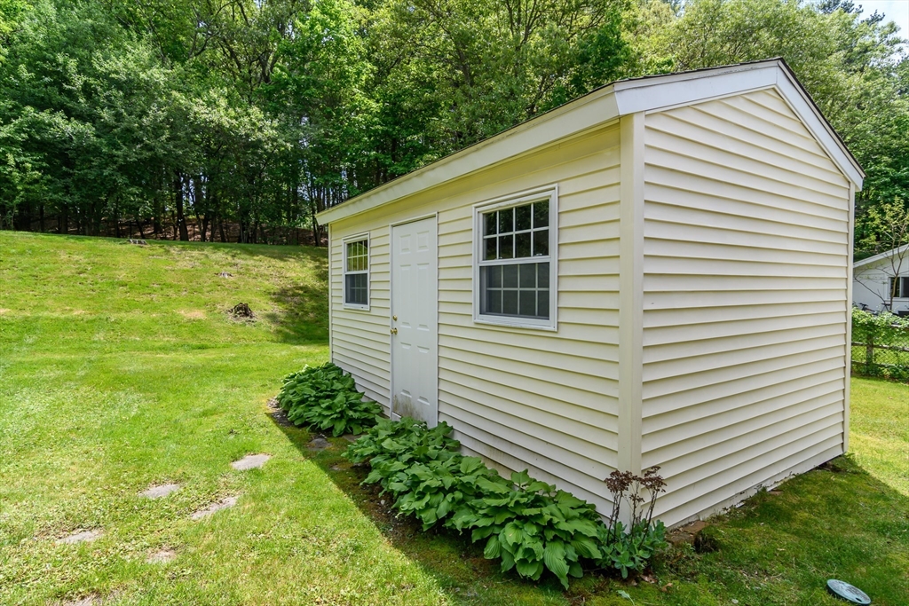 33 Eisenhower Road Framingham, MA 01701 - Photo 20 of 20 a view of a backyard with plants and large trees