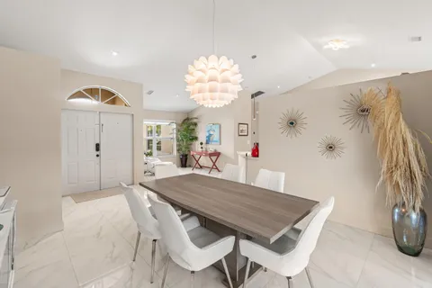 a view of a dining room with furniture and chandelier
