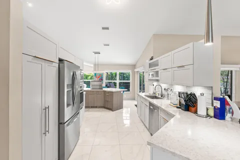a kitchen with stainless steel appliances a refrigerator and a sink