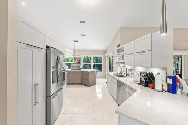 a kitchen with stainless steel appliances a refrigerator and a sink