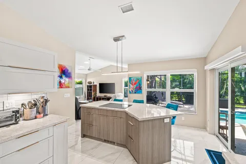 a kitchen with stainless steel appliances a refrigerator and a stove top oven