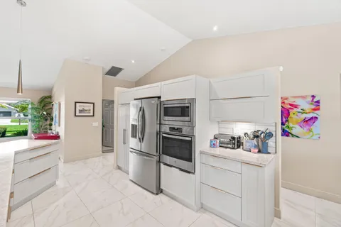 a kitchen with stainless steel appliances kitchen island granite countertop a sink and cabinets