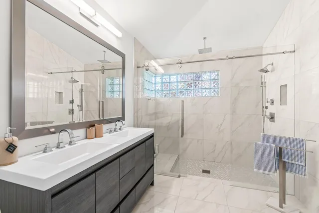 a bathroom with a shower and a sink