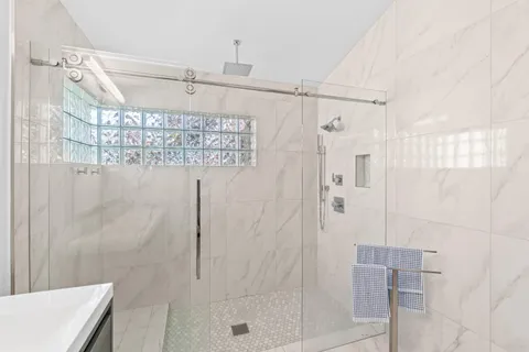 a en suite bathroom with a double vanity sink and a mirror