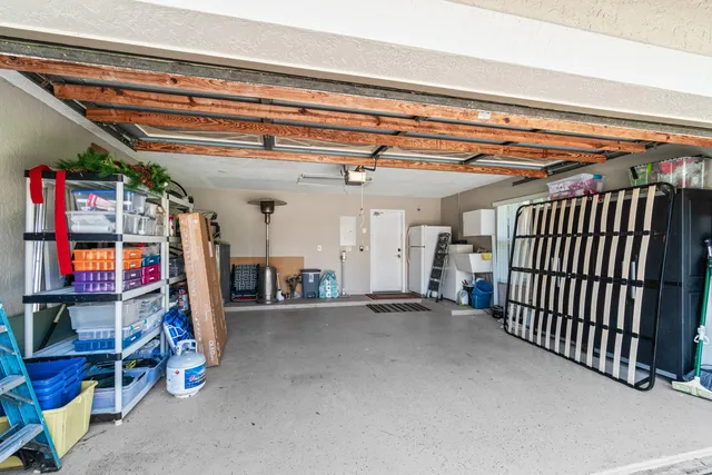 a view of a living room and floor to ceiling window furniture and garden