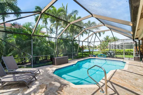 a view of a patio with table and chairs under an umbrella