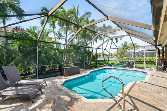 a view of a patio with table and chairs under an umbrella