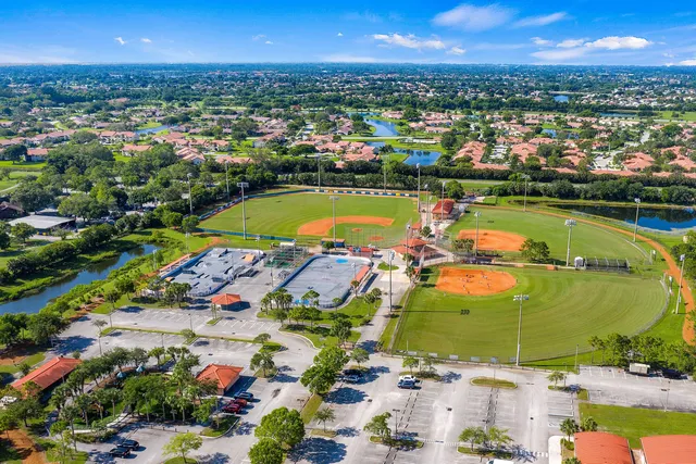 an aerial view of a city with lots of residential buildings and mountain view in back