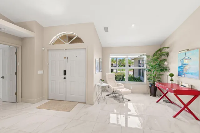 a living room with furniture a rug and white walls