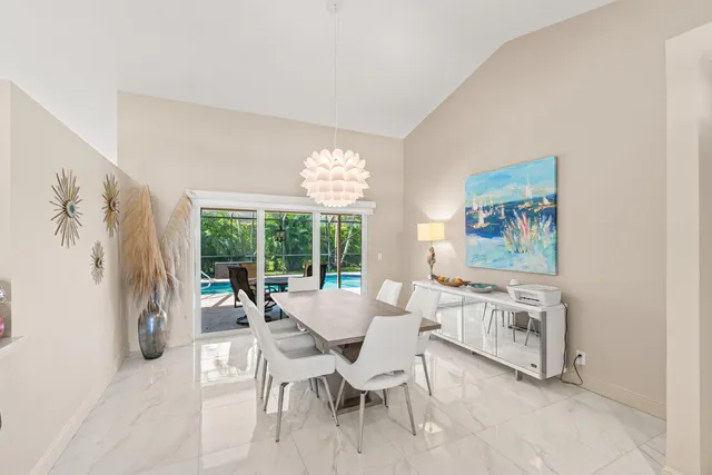 a dining room with furniture and a large window