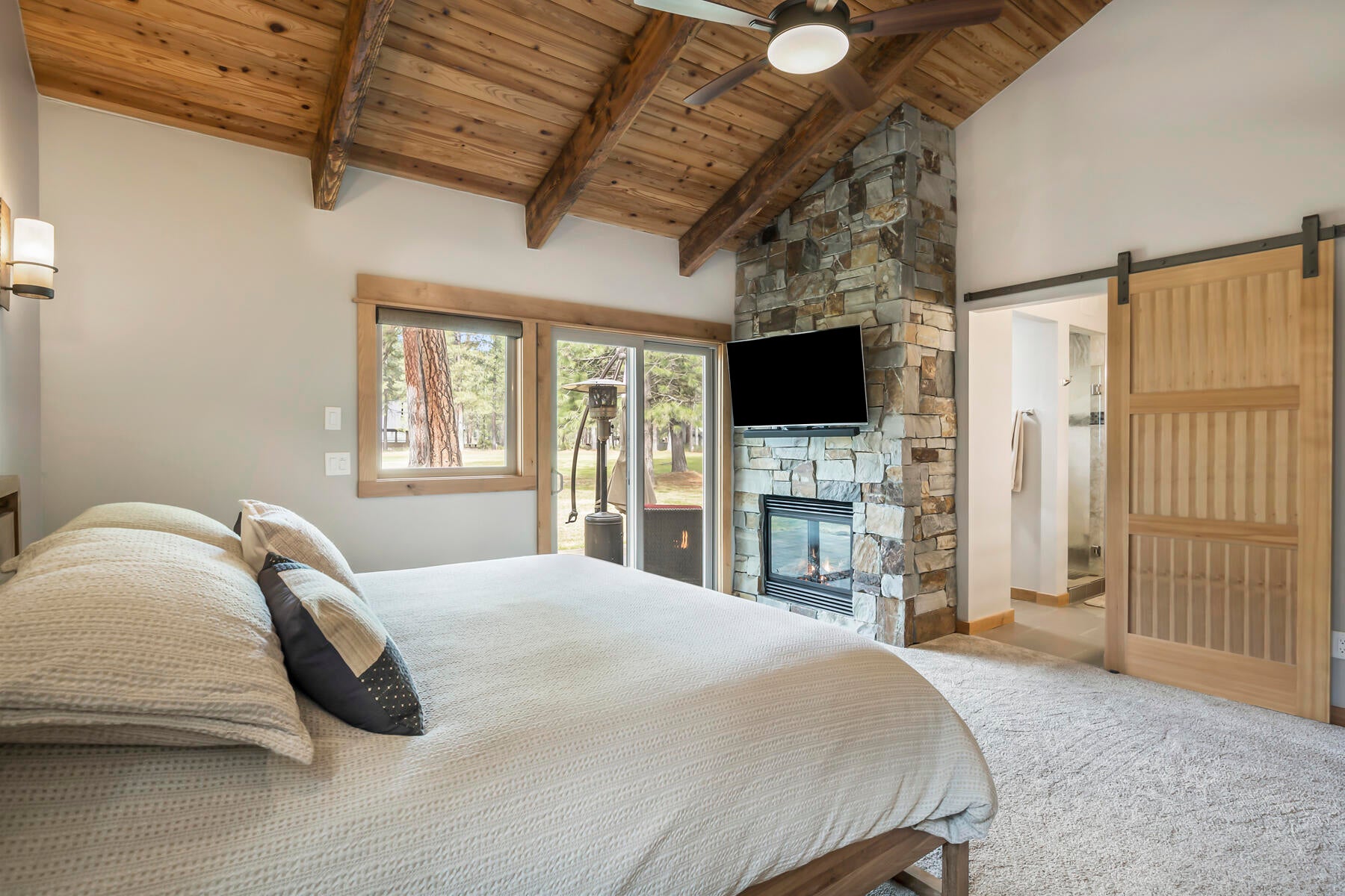 13303 Betony Black Butte Ranch, OR 97759 - Photo 23 of 42 Stone fireplace and barn doors