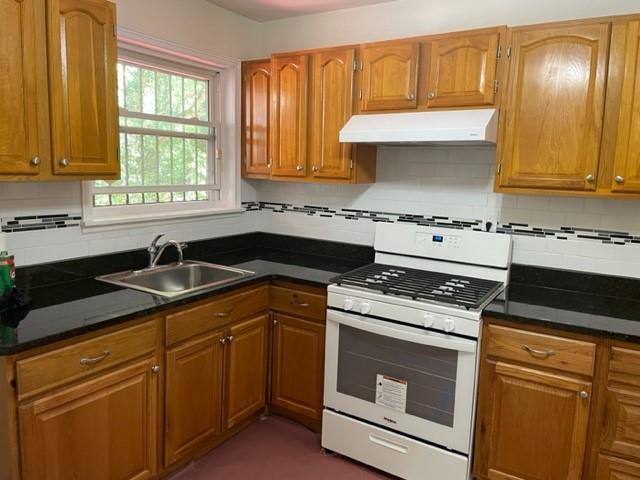 672 Clifton Road Southeast Atlanta, GA 30316 - Photo 4 of 7 a kitchen with granite countertop cabinets stainless steel appliances a sink and window