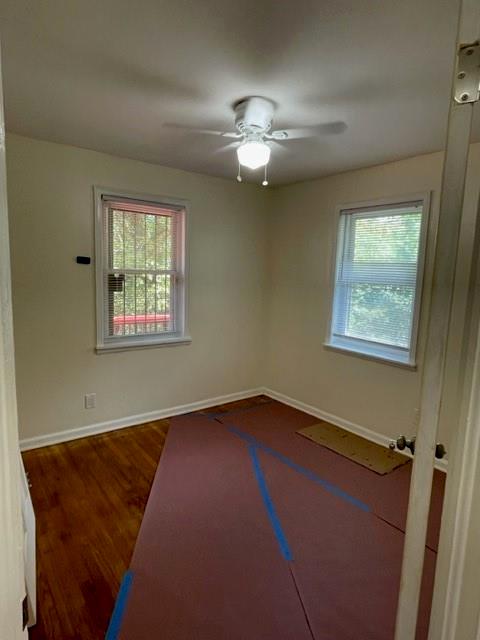 672 Clifton Road Southeast Atlanta, GA 30316 - Photo 6 of 7 a view of an empty room with a window and wooden floor
