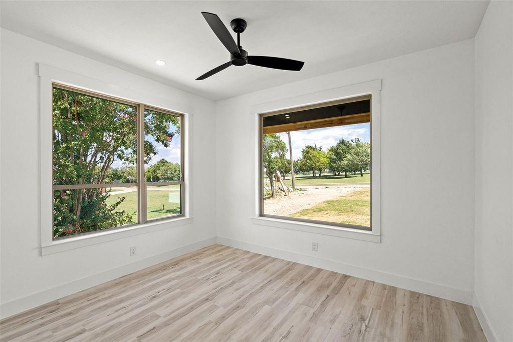 1017 Cedarcrest Drive Mesquite, TX 75149 - Photo 13 of 20 a view of an empty room with wooden floor and a window