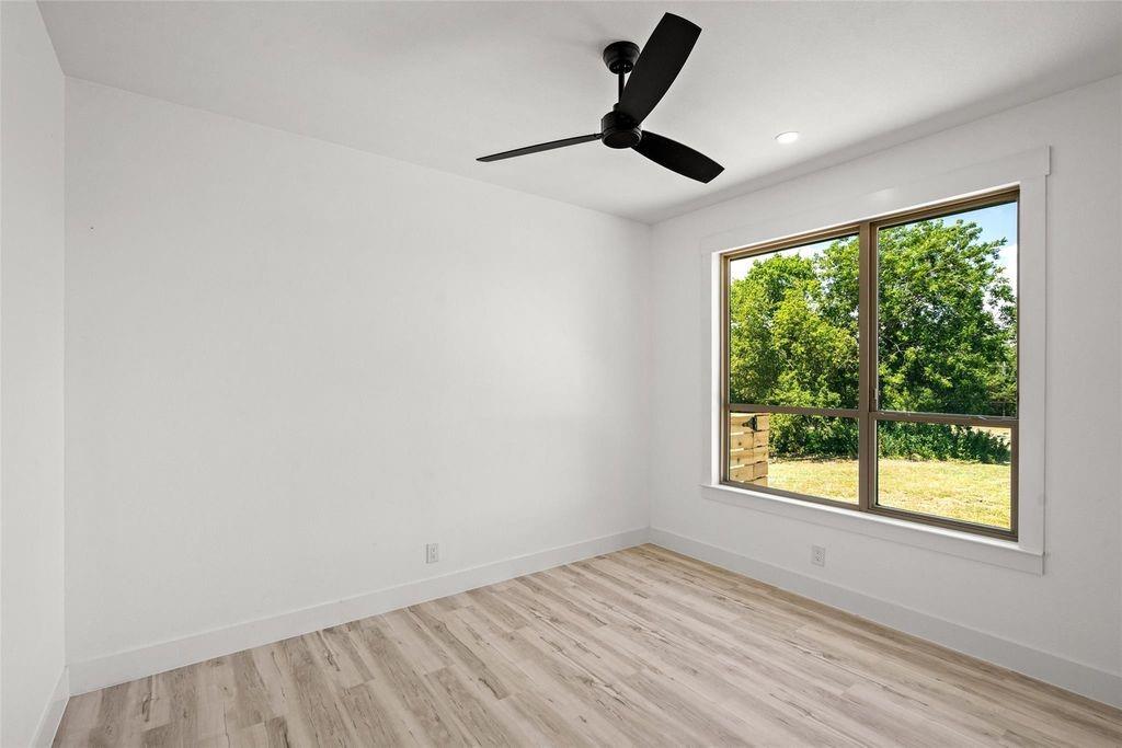 1017 Cedarcrest Drive Mesquite, TX 75149 - Photo 15 of 20 a view of empty room with wooden floor and fan