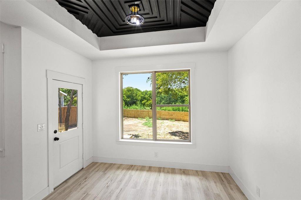 1017 Cedarcrest Drive Mesquite, TX 75149 - Photo 6 of 20 a view of an empty room with wooden floor and a window