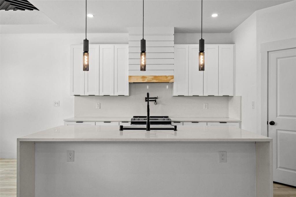 1017 Cedarcrest Drive Mesquite, TX 75149 - Photo 7 of 20 a kitchen with stainless steel appliances a white cabinets and wooden floor
