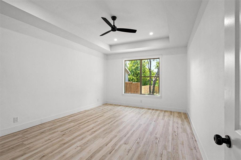 1017 Cedarcrest Drive Mesquite, TX 75149 - Photo 9 of 20 an empty room with wooden floor ceiling fan and windows