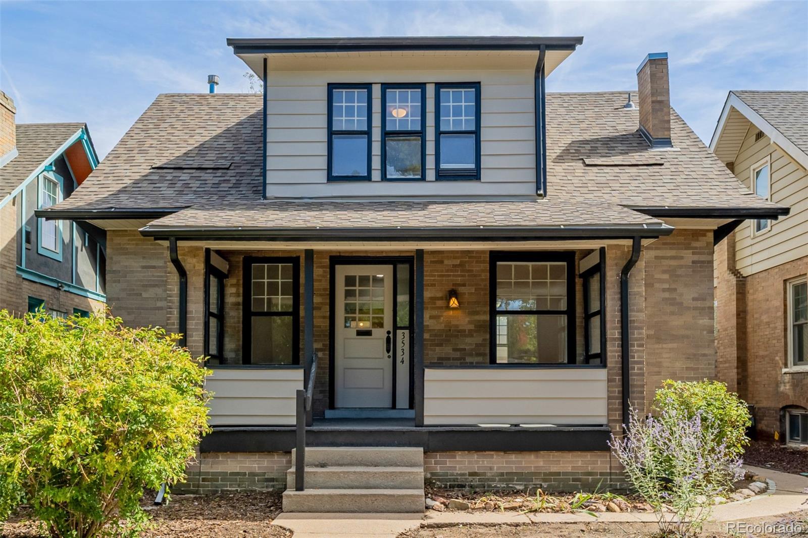3534 Clay Street Denver, CO 80211 - Photo 1 of 50 a front view of a house with a garden