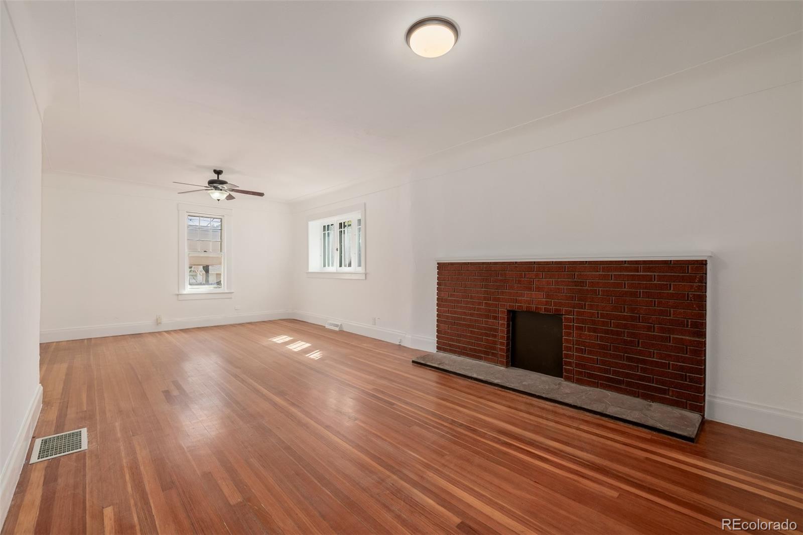 3534 Clay Street Denver, CO 80211 - Photo 11 of 50 wooden floor in an empty room with a fireplace