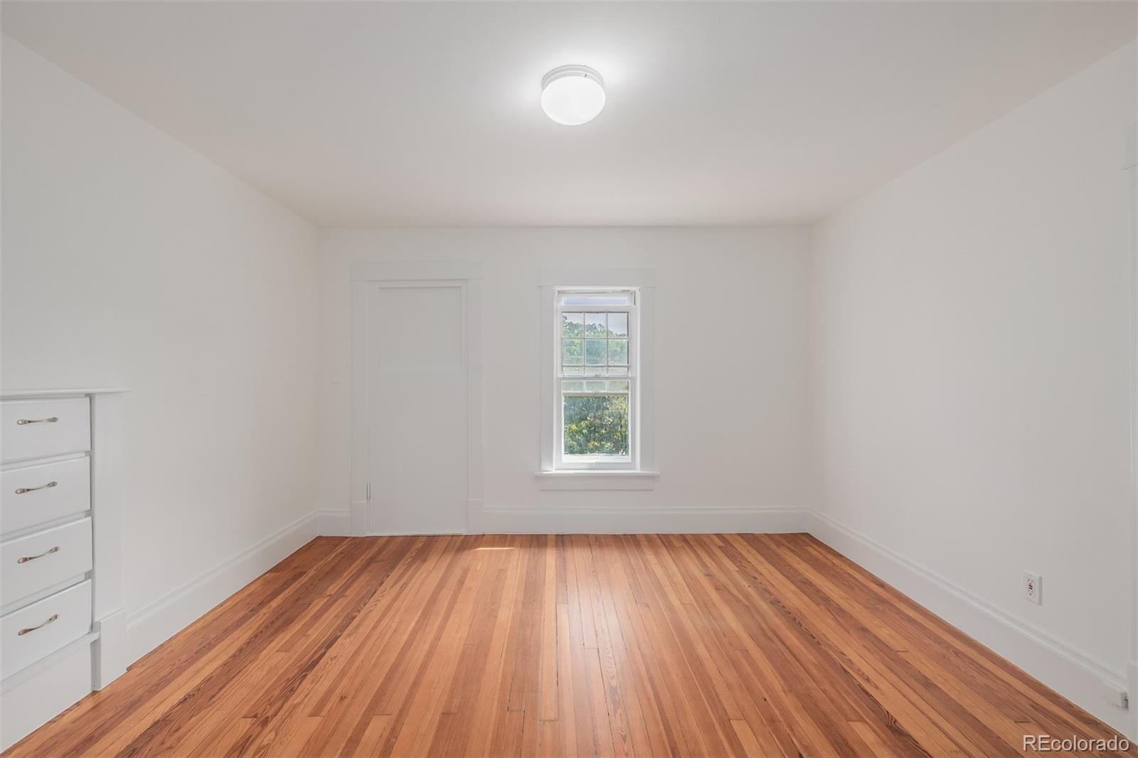 3534 Clay Street Denver, CO 80211 - Photo 17 of 50 an empty room with wooden floor and windows