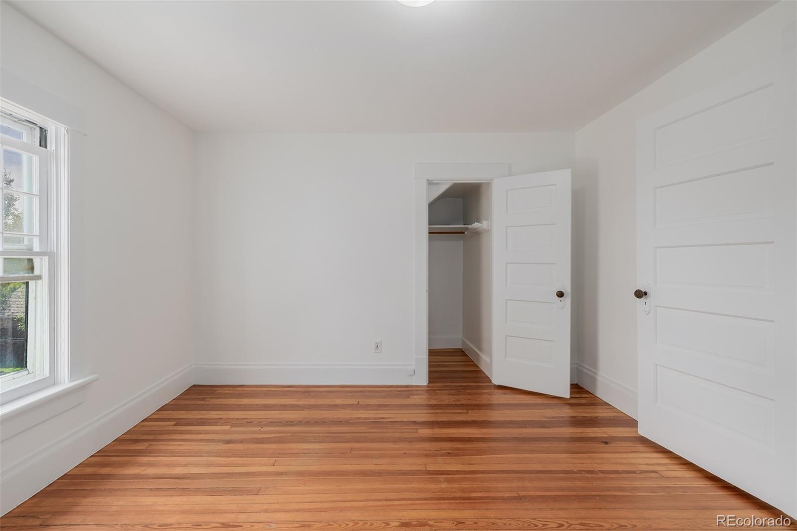 3534 Clay Street Denver, CO 80211 - Photo 19 of 50 a view of an empty room with wooden floor and a window