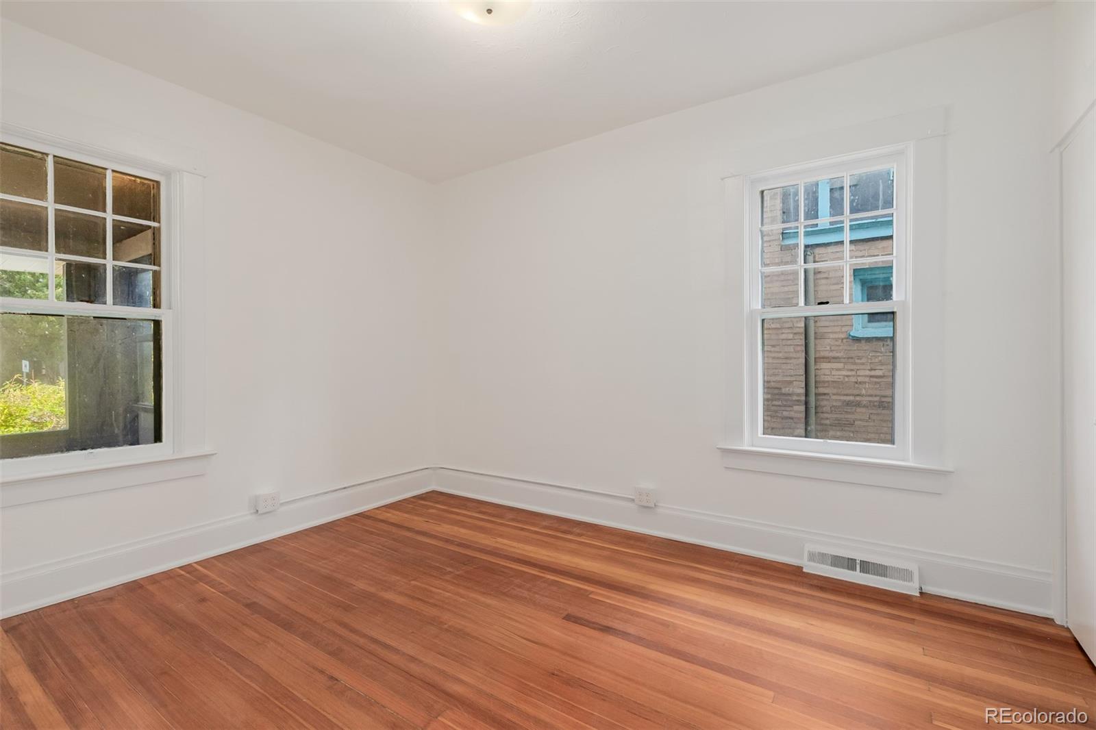 3534 Clay Street Denver, CO 80211 - Photo 24 of 50 a view of an empty room with wooden floor and a window