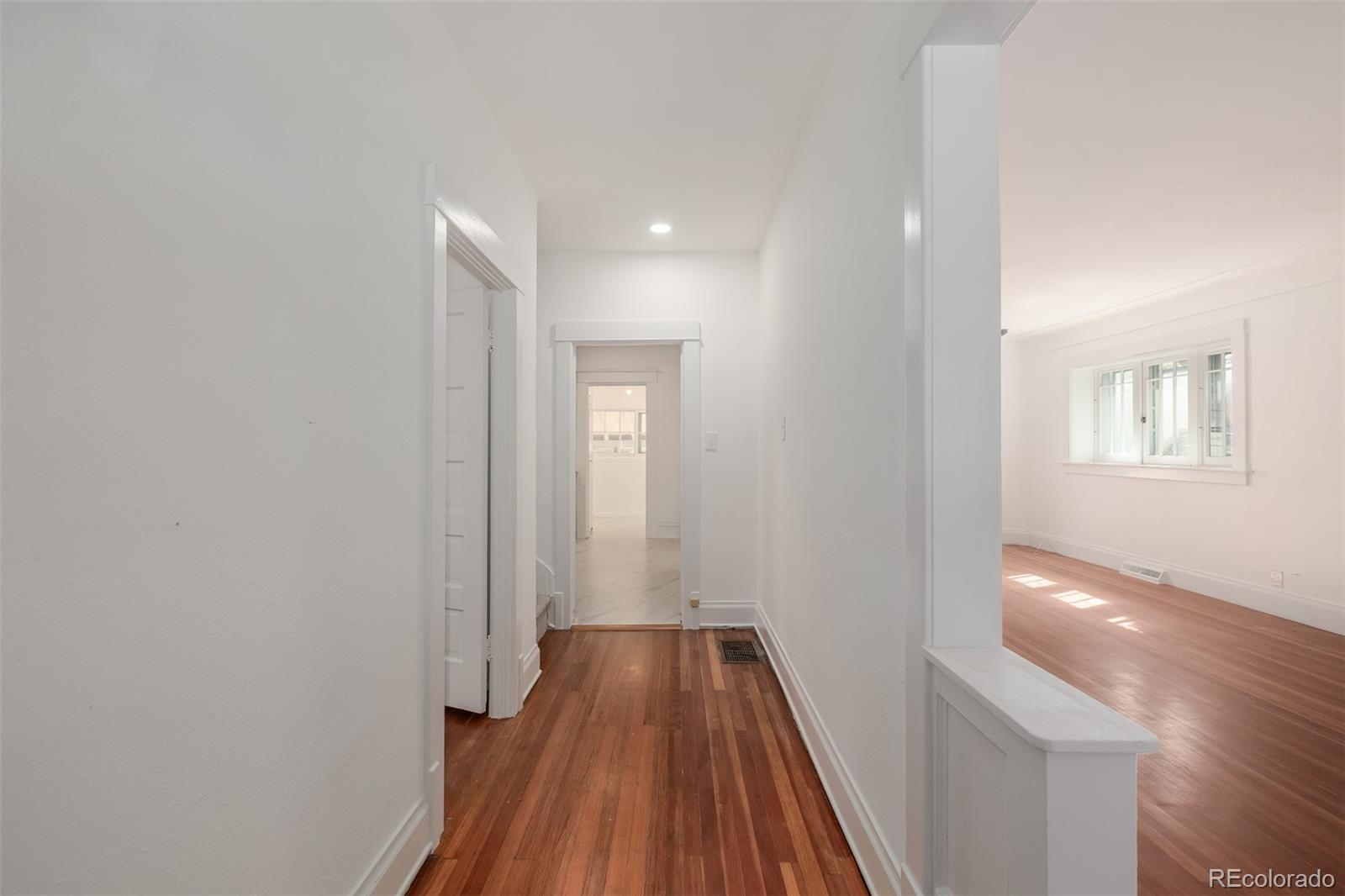 3534 Clay Street Denver, CO 80211 - Photo 27 of 50 a view of a hallway with wooden floor and a bathroom