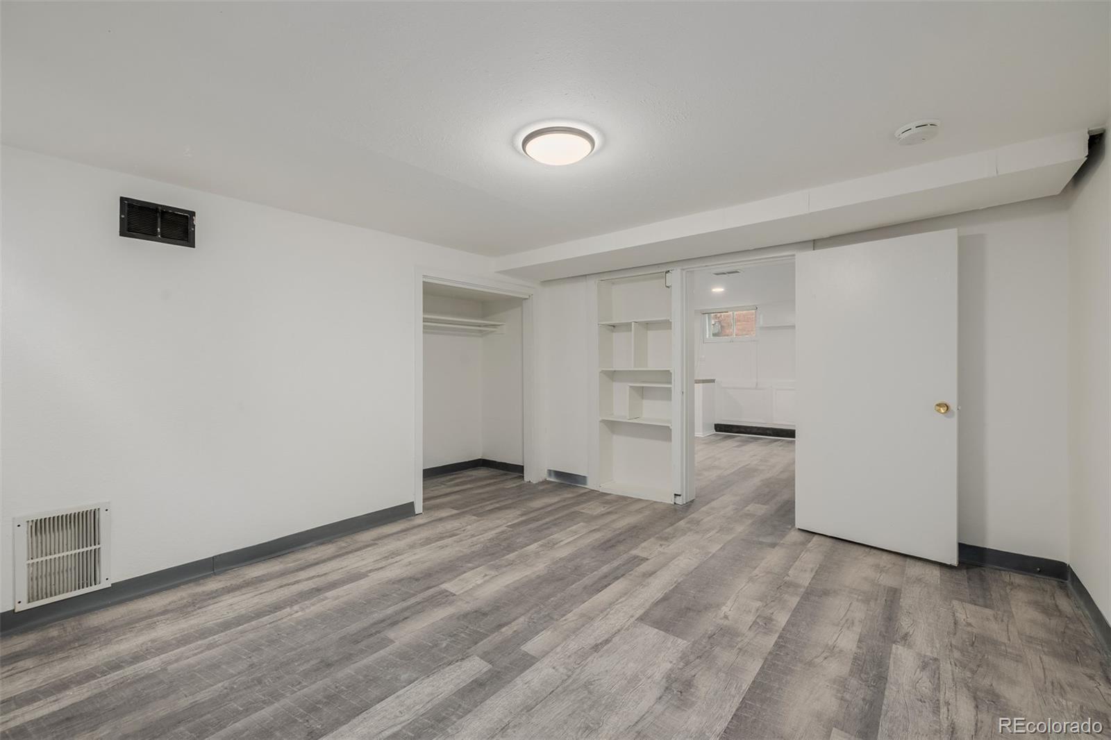 3534 Clay Street Denver, CO 80211 - Photo 29 of 50 a view of empty room with wooden floor and cabinet