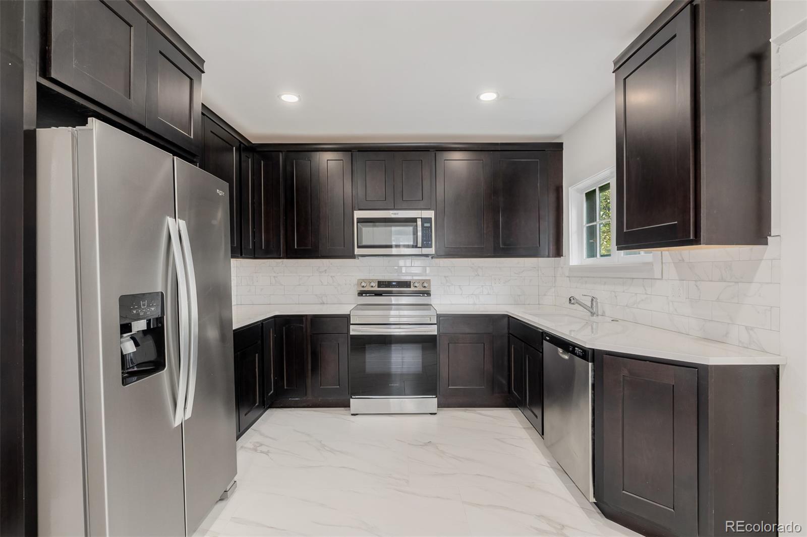 3534 Clay Street Denver, CO 80211 - Photo 3 of 50 a kitchen with stainless steel appliances granite countertop a refrigerator and a sink