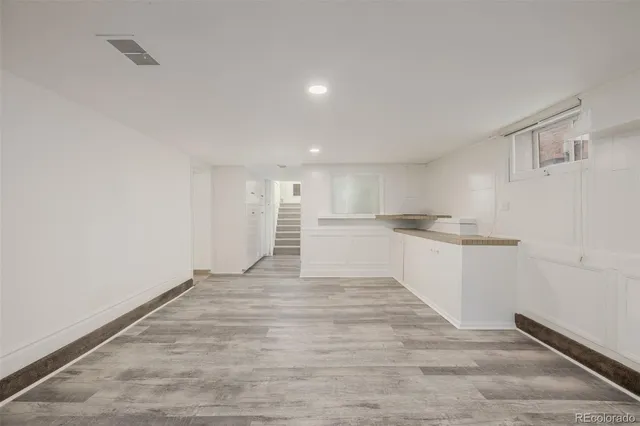 a view of a kitchen with wooden floor