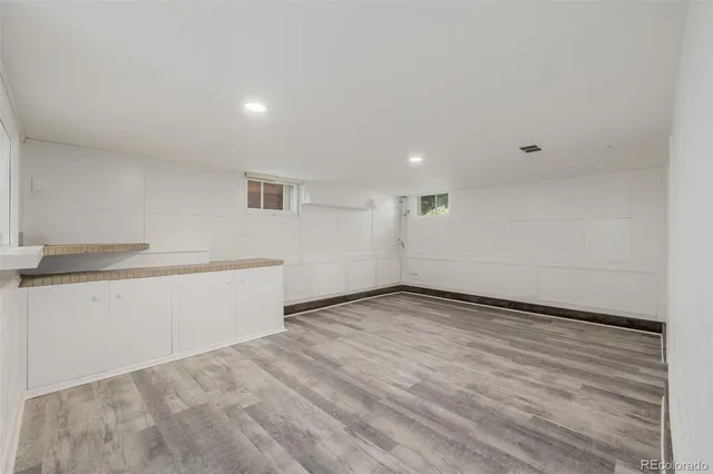 a view of a room with wooden floor and white walls