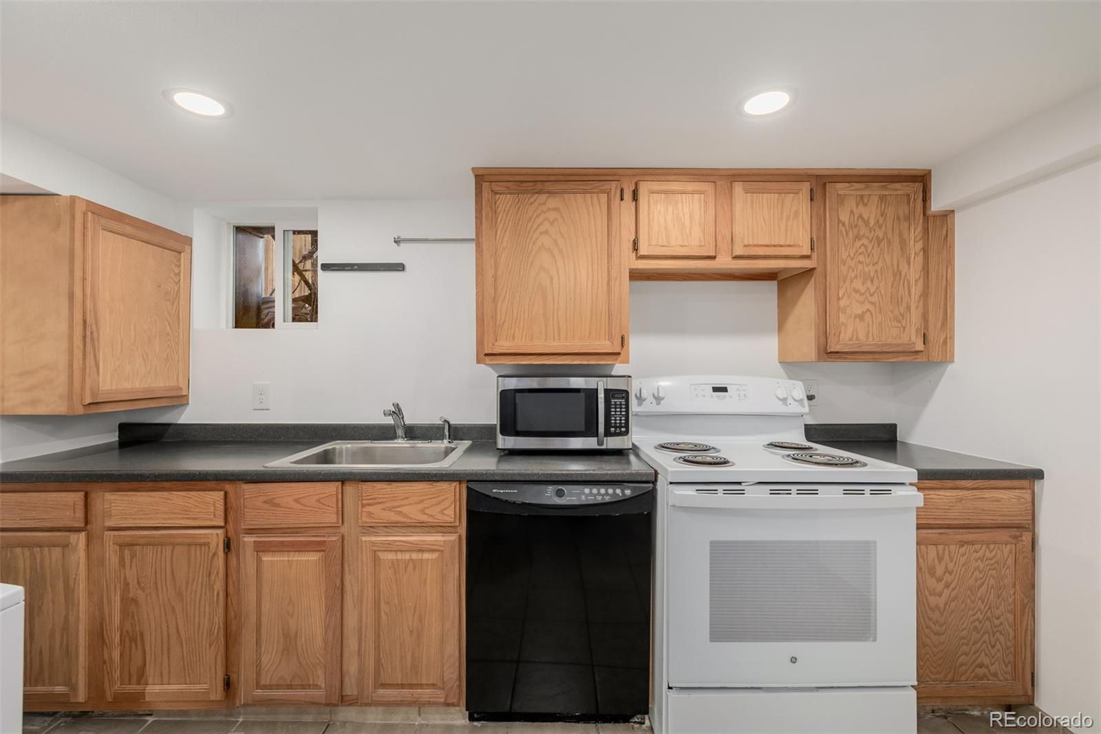 3534 Clay Street Denver, CO 80211 - Photo 38 of 50 a kitchen with granite countertop white cabinets and stainless steel appliances