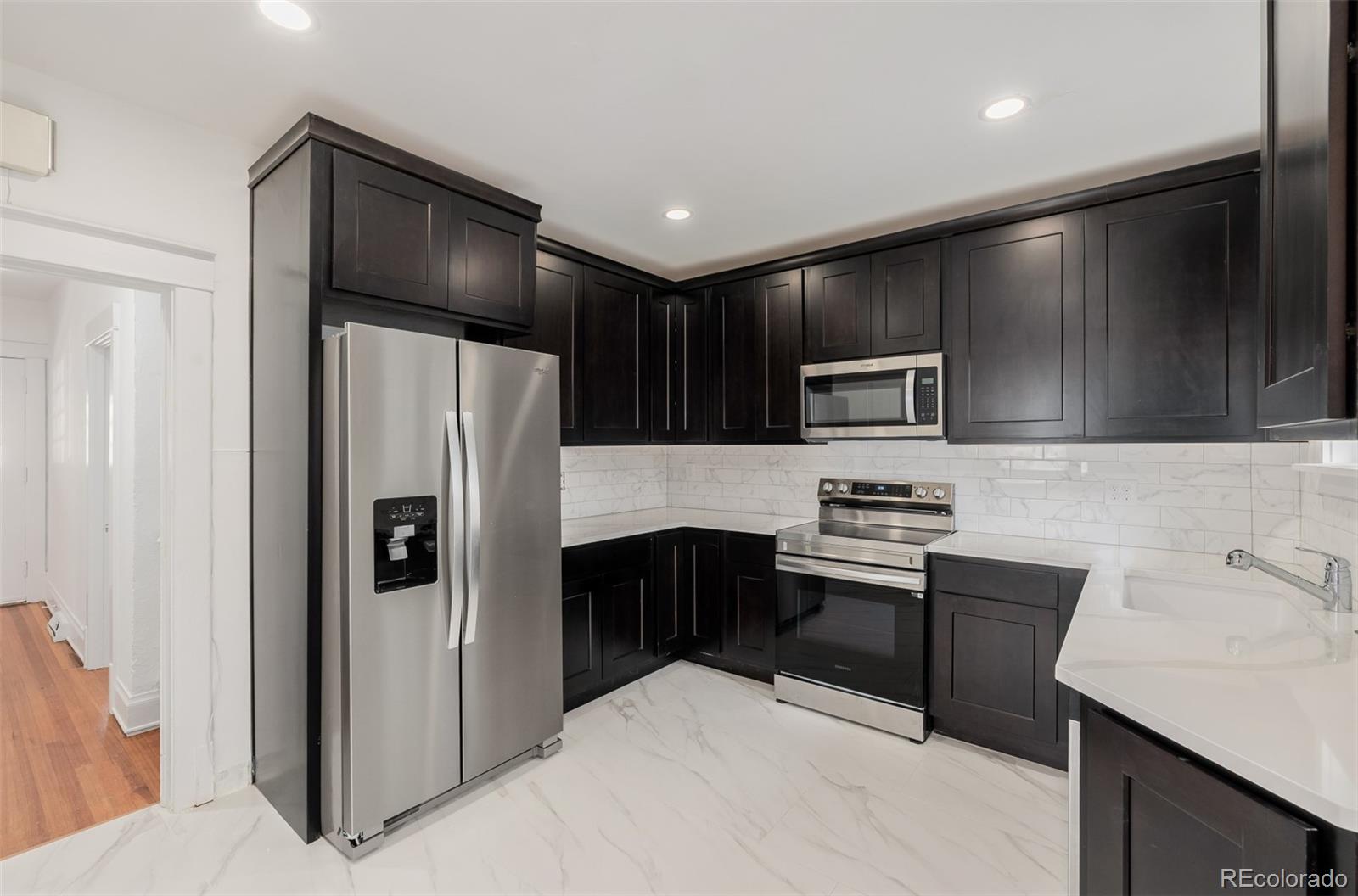 3534 Clay Street Denver, CO 80211 - Photo 4 of 50 a kitchen with stainless steel appliances granite countertop a refrigerator and a stove top oven