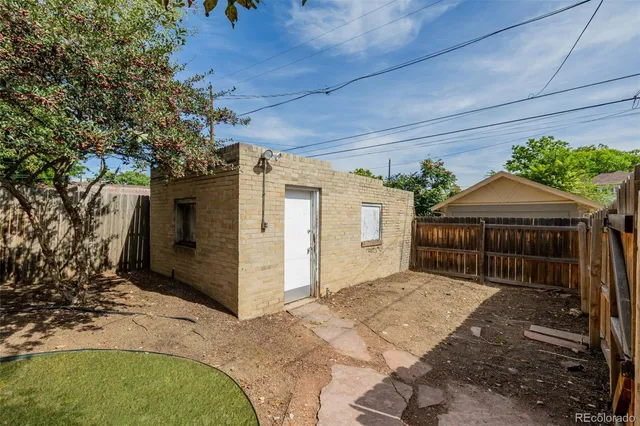 a front view of a house with a garden and trees