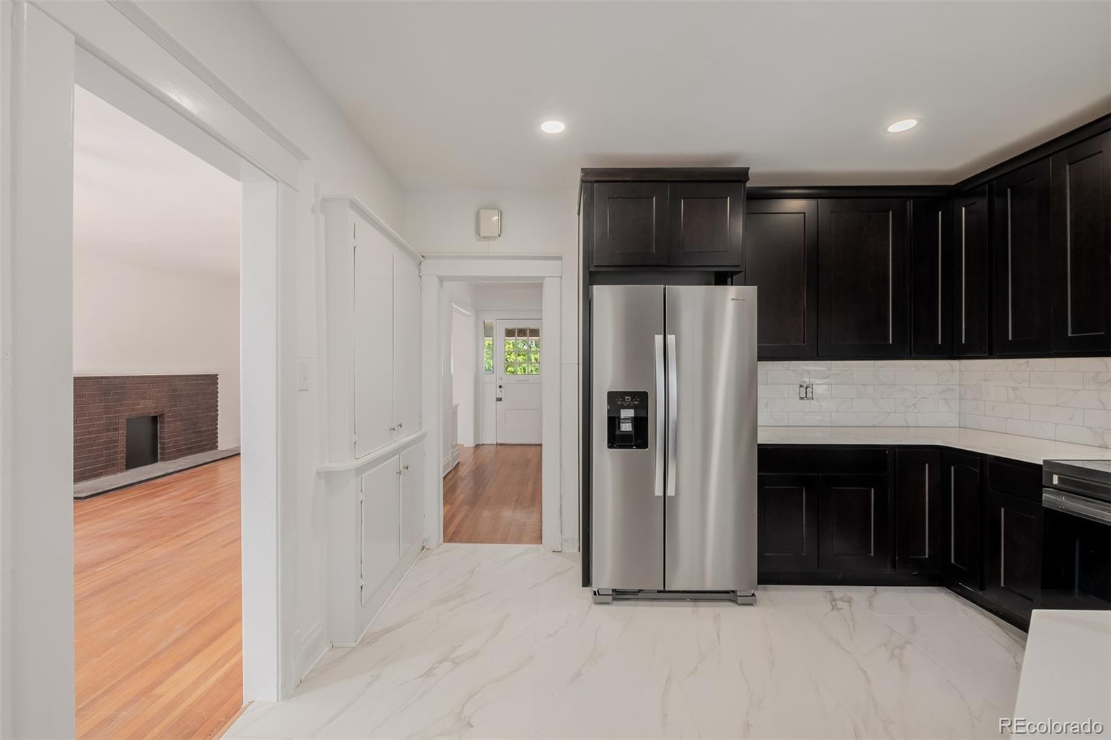 3534 Clay Street Denver, CO 80211 - Photo 6 of 50 a kitchen with stainless steel appliances a refrigerator and a stove