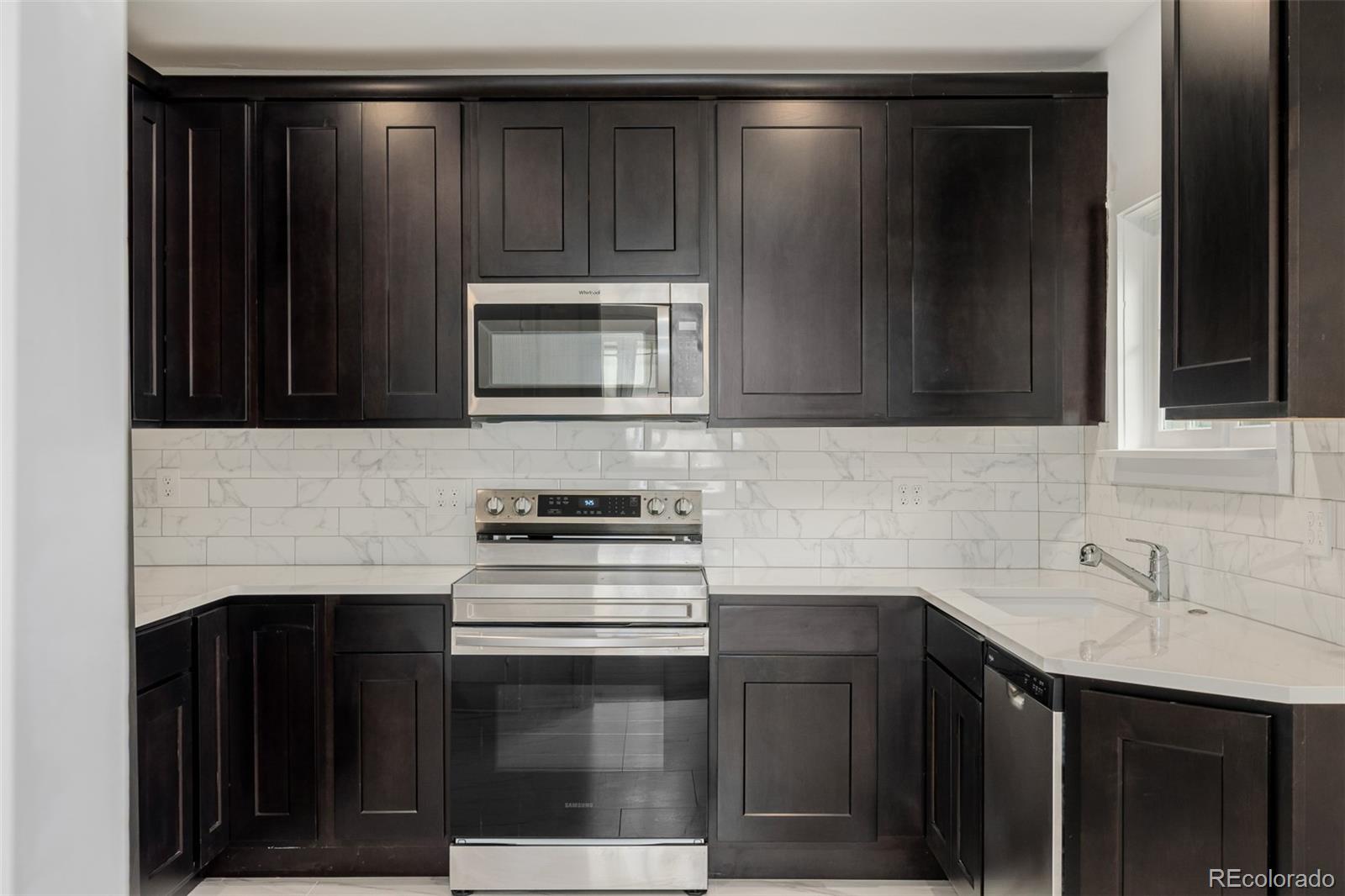 3534 Clay Street Denver, CO 80211 - Photo 7 of 50 a kitchen with a sink stove and microwave