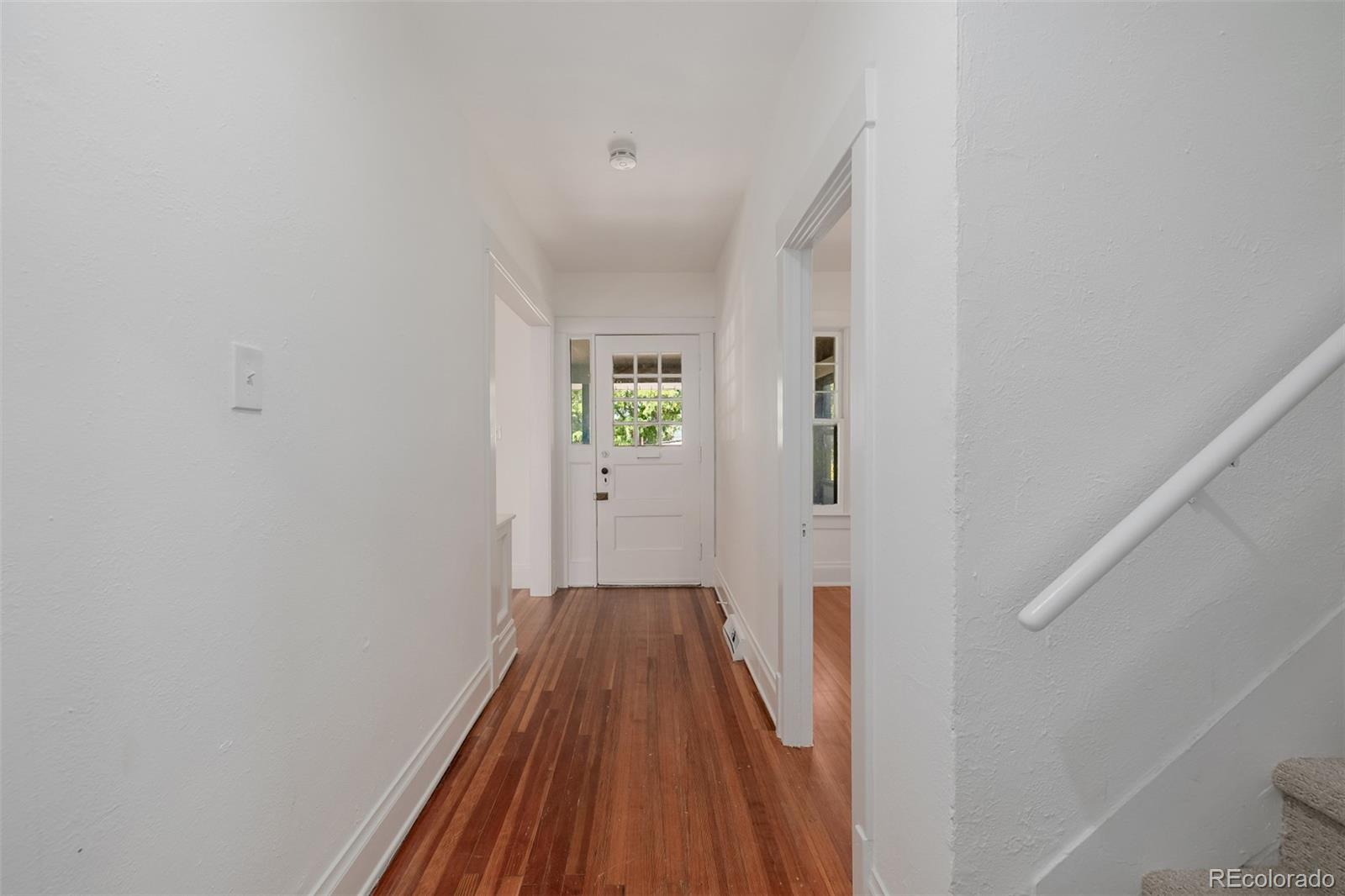 3534 Clay Street Denver, CO 80211 - Photo 9 of 50 a view of a hallway with wooden floor and staircase