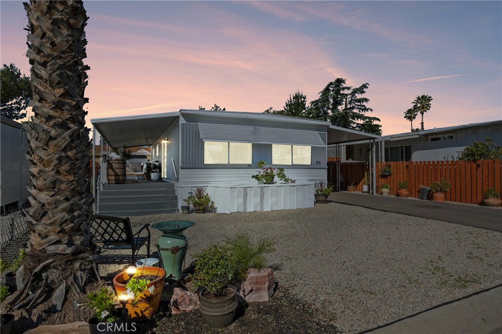 1025 South Riverside Avenue, Unit 25 Rialto, CA 92376 - Photo 1 of 1 a front view of a house with a yard and a garden